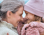 Happy senior woman, family and girl spending quality time together in the park during autumn. Cute little child and her grandmother bonding outdoor and smile with love, care and happiness in winter