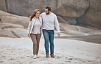 Happy couple on beach, walking during date and travel, holiday together with love and care outdoor. Love, man and woman smile on romantic walk with sand, happiness and enjoy honeymoon in South Africa