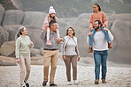 Family, children and beach with grandparents, parents and grandkids walking on the sand at the coast together. Summer, travel and love with a man, woman and kids bonding on a coastal walk outdoor