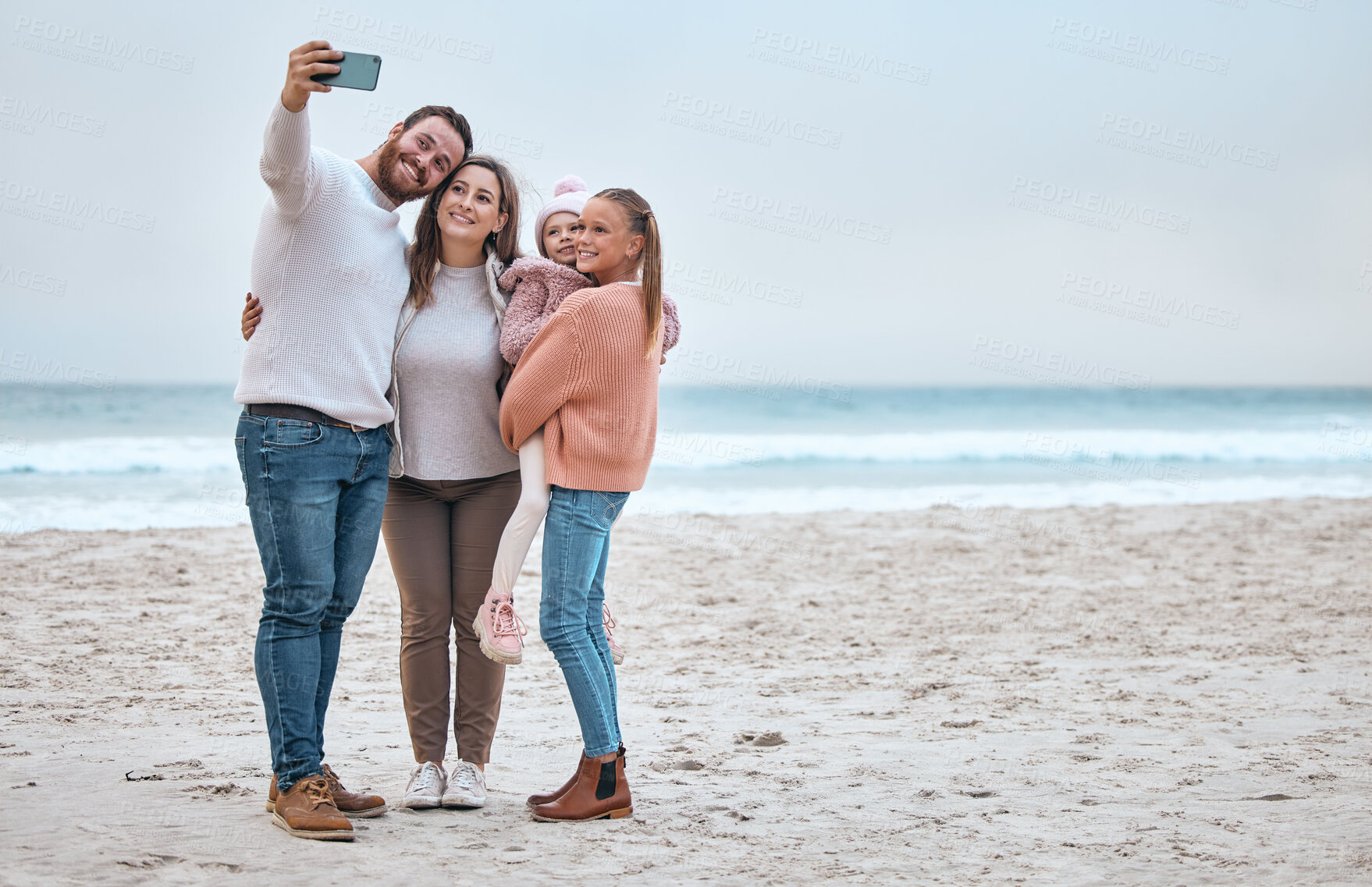 Buy stock photo Beach, selfie and happy family smile, relax and bond at the ocean, hug and enjoy trip in nature together. Travel, phone and family picture at the sea while on vacation in Canada with girl and parents