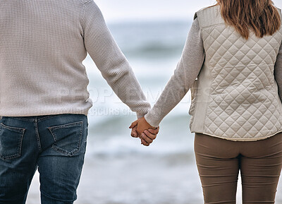 Buy stock photo Couple, holding hands and beach in travel, love or romance for relationship bonding in the outdoors. Hands of man and woman in trust, support or care on romantic walk or trip by the ocean water