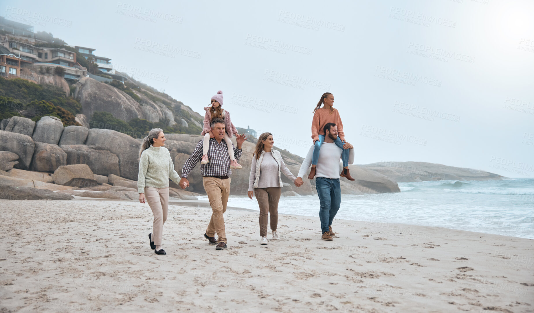 Buy stock photo Family, walking and holding hands on beach holiday vacation. Happy grandparents, parents and children smile together for love trust bonding holiday or quality time adventure on sand ocean water
