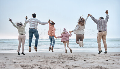 Buy stock photo Family at the beach, adventure and jump, generations love and care while holding hands and fun by the ocean. Big family travel, parents with grandparents and children together and freedom at sea.