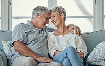 Buy stock photo Happy, smile and senior couple on sofa to relax, talk and bond in the living room of their home. Happiness, love and elderly man and woman in retirement sitting on couch together in lounge at a house