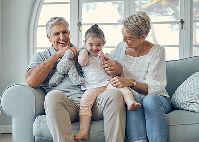 Buy stock photo Family, grandmother and grandfather with girl on sofa, having fun and bonding. Portrait, love and care of happy grandparents with kid or child on couch in living room enjoying quality time together.