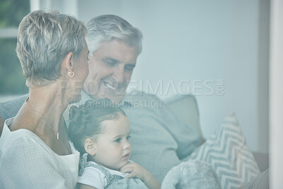 Buy stock photo Grandparents, girl and hug with family relax, love and care on lounge sofa in home. Smile, play and happy children, senior grandma and elderly grandpa bond together for quality time on a house couch