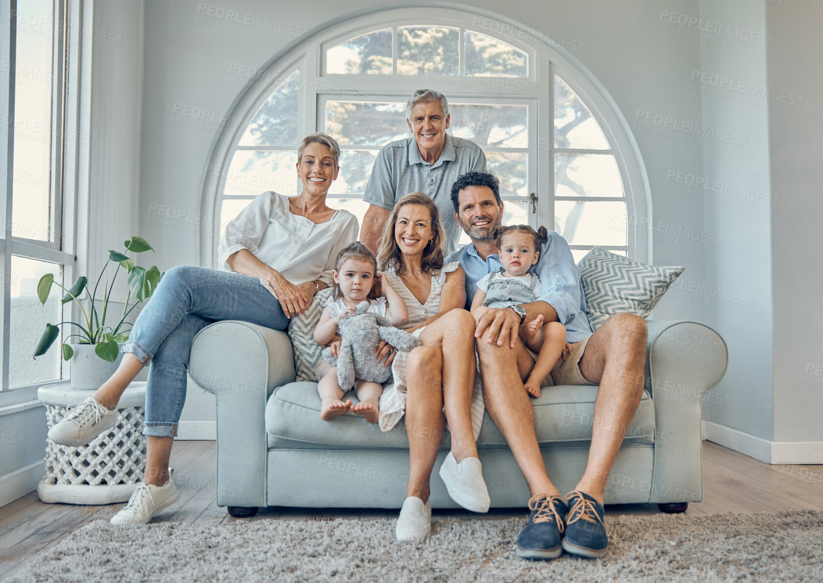 Buy stock photo Family, children and grandparents on a sofa in the living room of their home together during a visit. Kids, love and portrait with a mother, father and relatives sitting on a couch while bonding