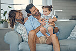 Family, children and baby with a girl, father and mother sitting on a sofa in the living room of their home together. Love, kids and happy with a man, woman and daughter bonding in their house