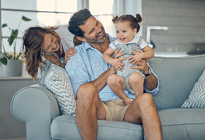 Buy stock photo Family, children and baby with a girl, father and mother sitting on a sofa in the living room of their home together. Love, kids and happy with a man, woman and daughter bonding in their house