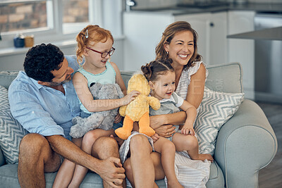 Buy stock photo Family, happy and parents with children, love and spending quality time together on sofa in family home. Mother, father and kids smile and have fun, bonding and care with soft toy in living room.