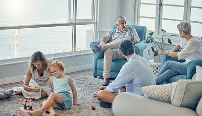 Buy stock photo Family, generations and love together in living room with parents, grandparents and child play with toys and bonding. Big family, men with women and kid at home, spending quality time and care.