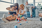 Mother, children and digital tablet in living room with family relax, play and bond in their home together. Learning, kids and mom watching online game, cartoon and entertainment with girl on carpet