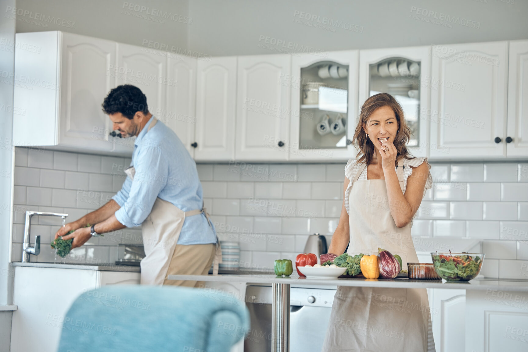 Buy stock photo Health cooking, eating and couple in a kitchen with vegetables and salad for vitamins and wellness. Diet, nutrition and food recipe of a wife and man together making a healthy dinner meal at home