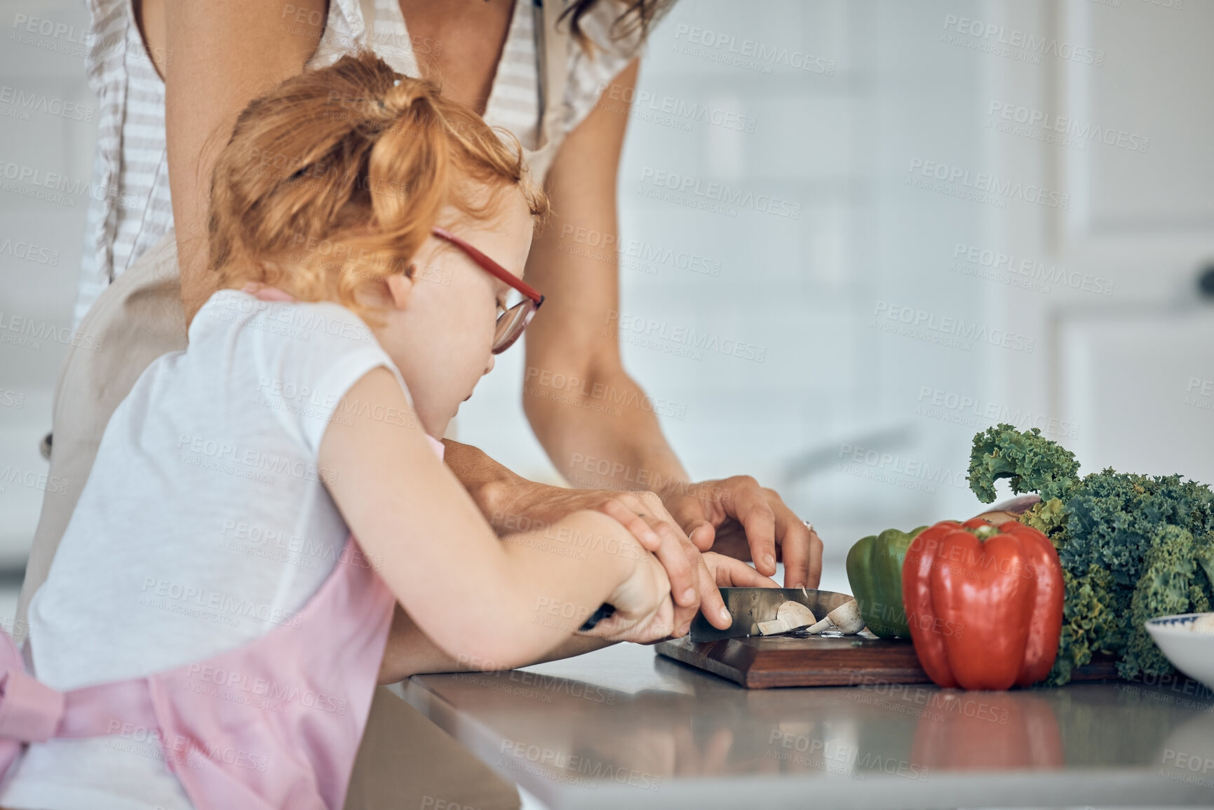 Buy stock photo Mother teaching, child cutting vegetable and learning skill in home kitchen together on counter. Girl knife focus, cooking education with mom teacher and cut vegetables for dinner food in house