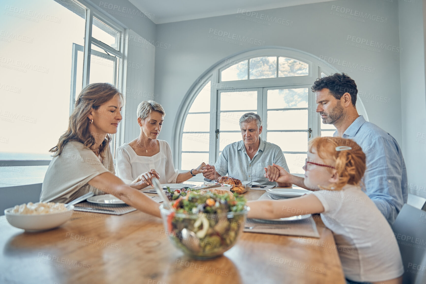 Buy stock photo Lunch, praying and family together at dining room table in home. Grandparents, child and parent teaching grace or spiritual religion prayer respect to kid before dinner in religious retirement house