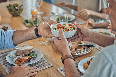 Buy stock photo Hands, food and family with a group of people gathered around a dining room table for a meal or feast at home. Salad, buffet and celebration with relatives eating lunch or supper together in a house