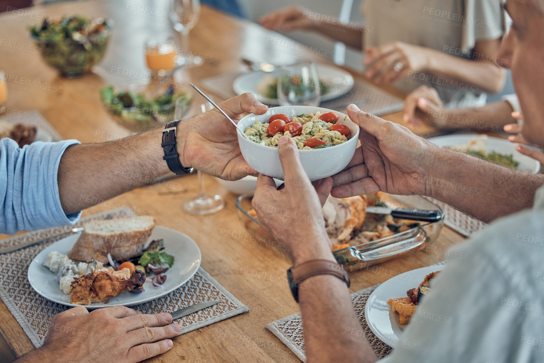 Buy stock photo Hands, food and family with a group of people gathered around a dining room table for a meal or feast at home. Salad, buffet and celebration with relatives eating lunch or supper together in a house