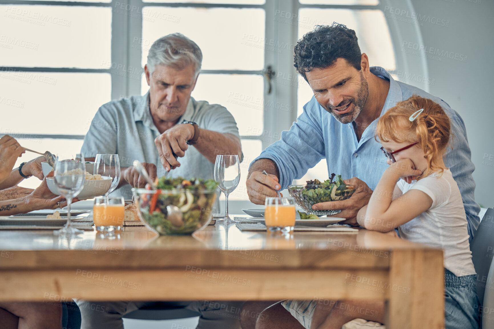 Buy stock photo Dinner, family and child eating food at dining room table together at retirement home. Senior grandparent, happy father and young girl upset about conversation or dad teaching child healthy lifestyle