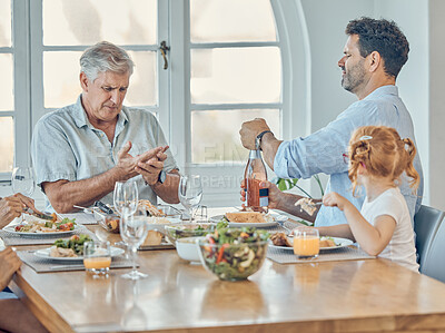 Buy stock photo Lunch, dining room and family eating together in celebration at a modern home with food and champagne. Hurt grandfather in retirement, father and child enjoying a food meal at a dinner table at house