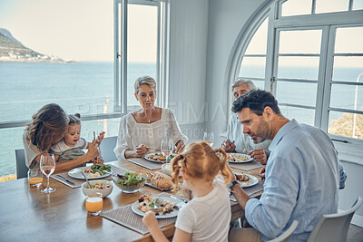 Buy stock photo Family, generations and food, eating together in family home by the beach, healthy meal, nutrition and bonding. Big family, parents with grandparents and children eat at house by coast of Australia.