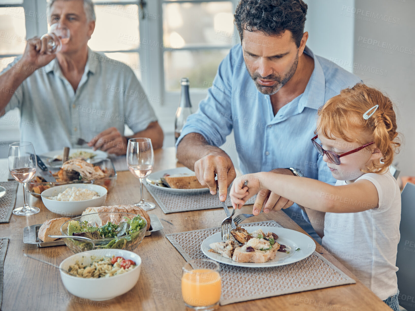 Buy stock photo Restaurant, daughter and father with cutting, food or meat on table for learning, teaching and help. Dad, girl and lunch together with fork, knife and plate and helping kid with meal with family