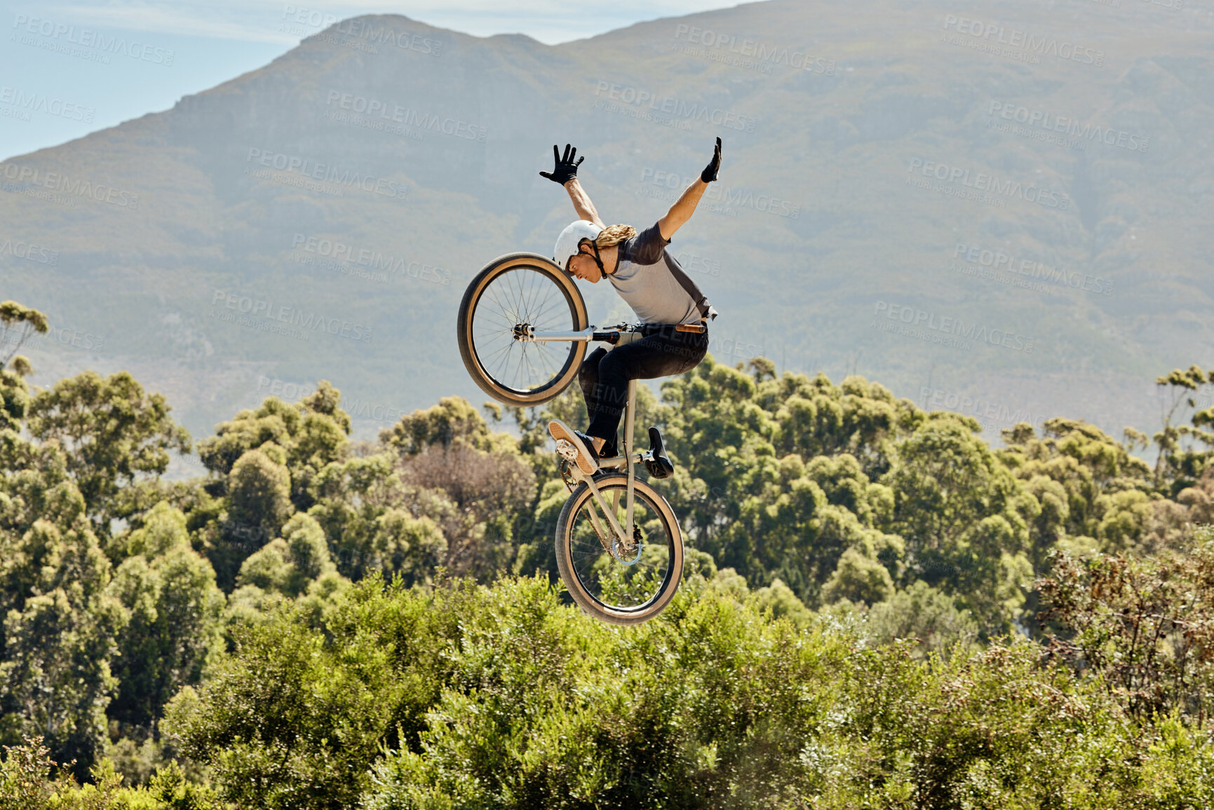 Buy stock photo Mountain bike, nature and sports man jump in air with outdoor adventure, journey and training in bush or forest mock up for marketing. Risk, danger and sport bicycle person in sky freedom and fitness