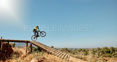 Buy stock photo Sports, mountain bike and ramp jump in nature, cycling 
and outdoors stunt performance. Fitness, workout and exercise of bmx athlete and racer on bicycle training for competition, race or contest.


