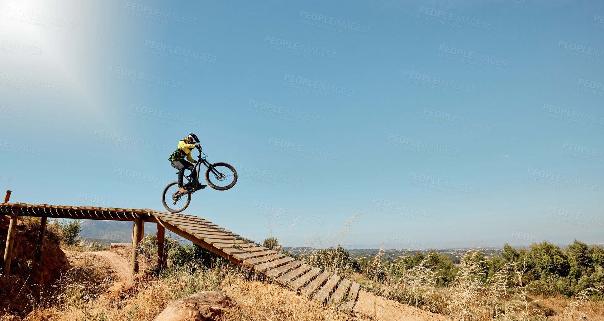 Buy stock photo Sports, mountain bike and ramp jump in nature, cycling 
and outdoors stunt performance. Fitness, workout and exercise of bmx athlete and racer on bicycle training for competition, race or contest.


