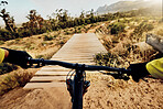 POV perspective, mountain bike and man cycling on hill, bridge and path for adventure, speed and sports challenge, action and off road race in nature. Bicycle handle, athlete and outdoor competition