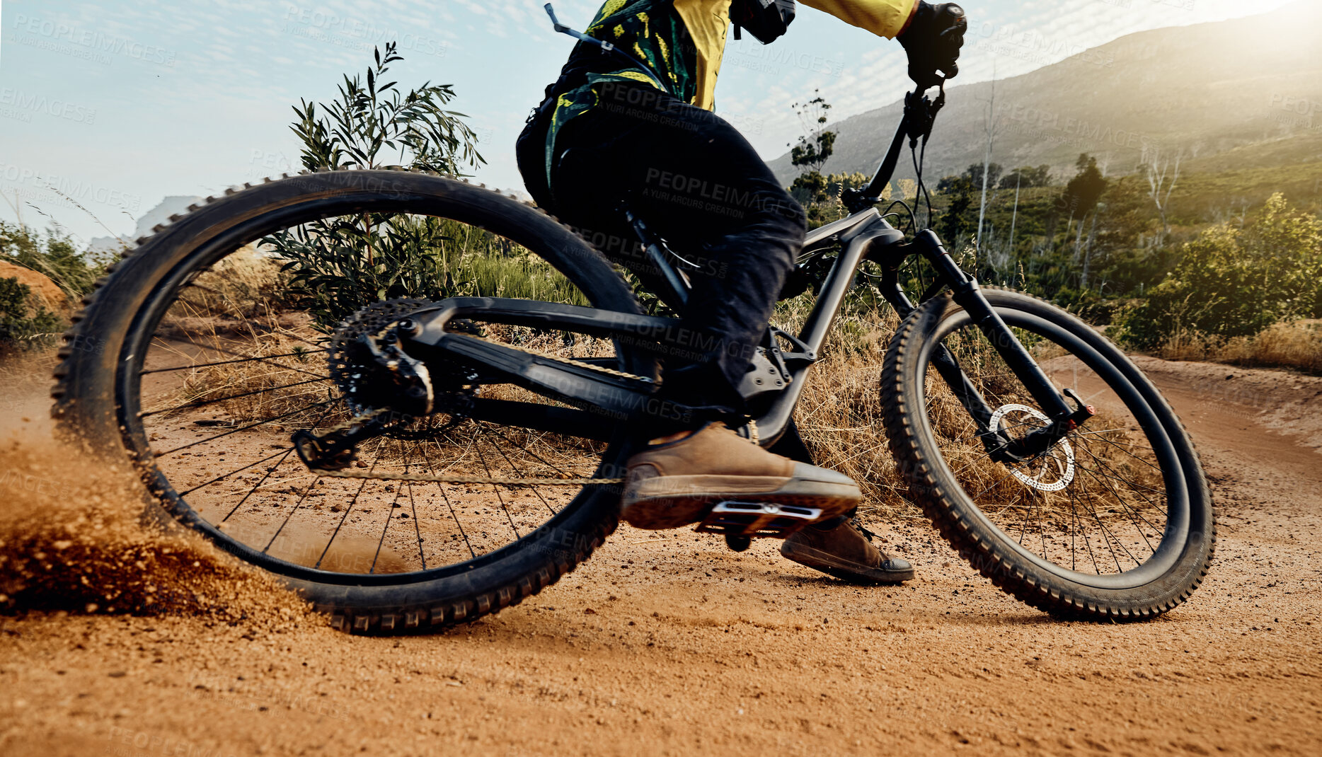 Buy stock photo Sports, action and biker dirt racing on mountain bike enjoying riding, cycling and moving with speed. Extreme sports, mountain biking and athlete drifting on dirt road for fitness, adrenaline and fun