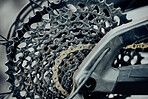 Bicycle, metal chain or wheel cassette in repair workshop, retail bike store or home garage in fixing, oil maintenance or upgrading. Zoom, texture or steel cycling mechanical engineering for bmx tire