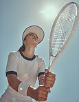 Professional tennis player, fitness and woman athlete playing sports, match and games with tennis racket on blue sky lens flare. Below of tennis girl with focus mindset in training to win competition