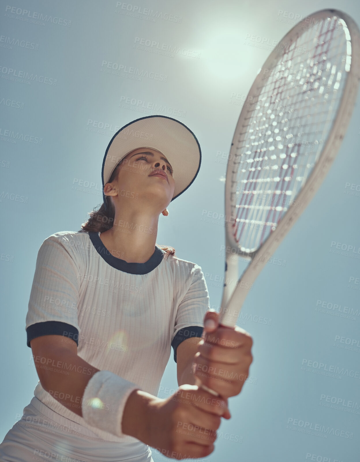 Buy stock photo Professional tennis player, fitness and woman athlete playing sports, match and games with tennis racket on blue sky lens flare. Below of tennis girl with focus mindset in training to win competition