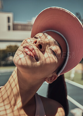 Buy stock photo Young woman, sunshine and happy outdoor, content and enjoy summer vacation for wellness, health and balance. Confident female, sunlight and with hat to cover face, happiness and with smile for joy