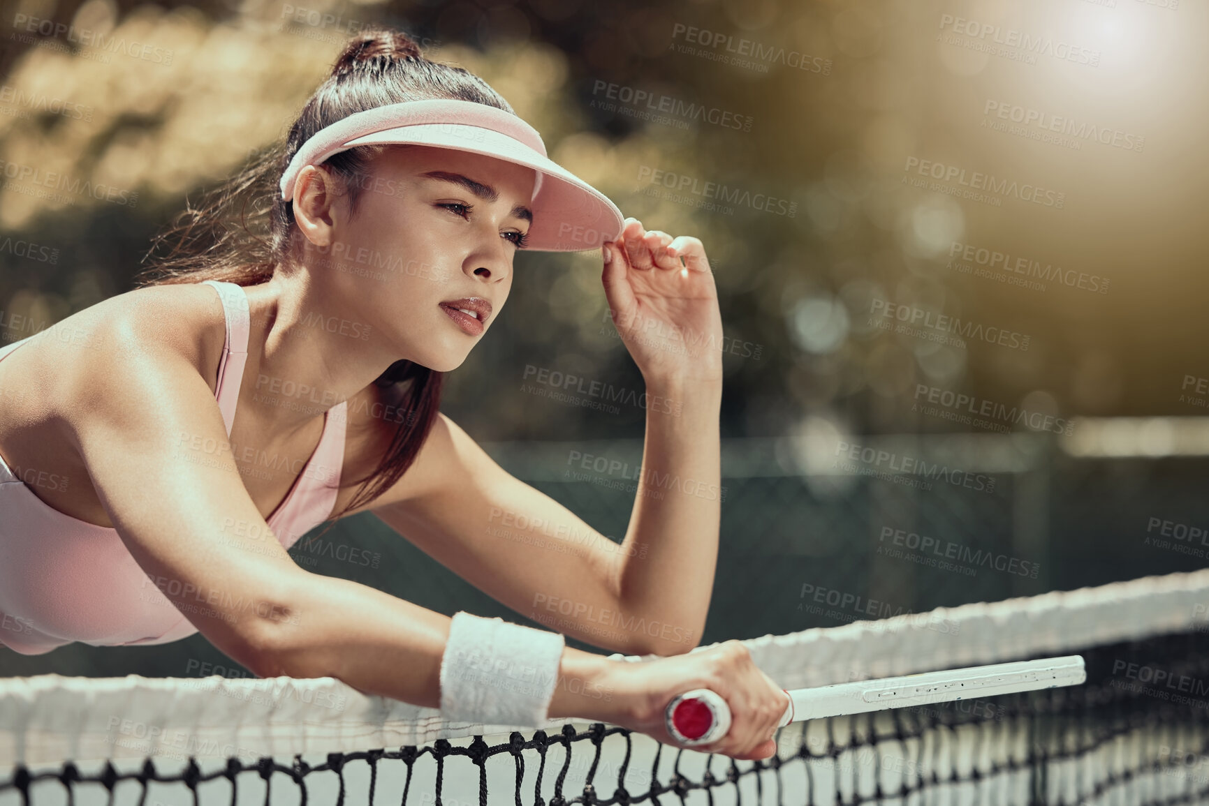 Buy stock photo Woman, tennis player and tired tennis athlete training with determination for fitness, exercise and outdoor tennis court summer workout. Competition game, girl resting on net and thirsty young adult 