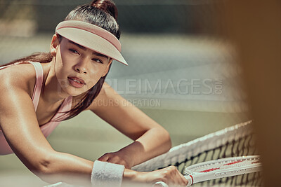 Buy stock photo Tennis, sports and woman on a break while playing game or training on an outdoor court. Fitness, workout and tired young athlete resting on net while practicing for exercise or skill on tennis court.
