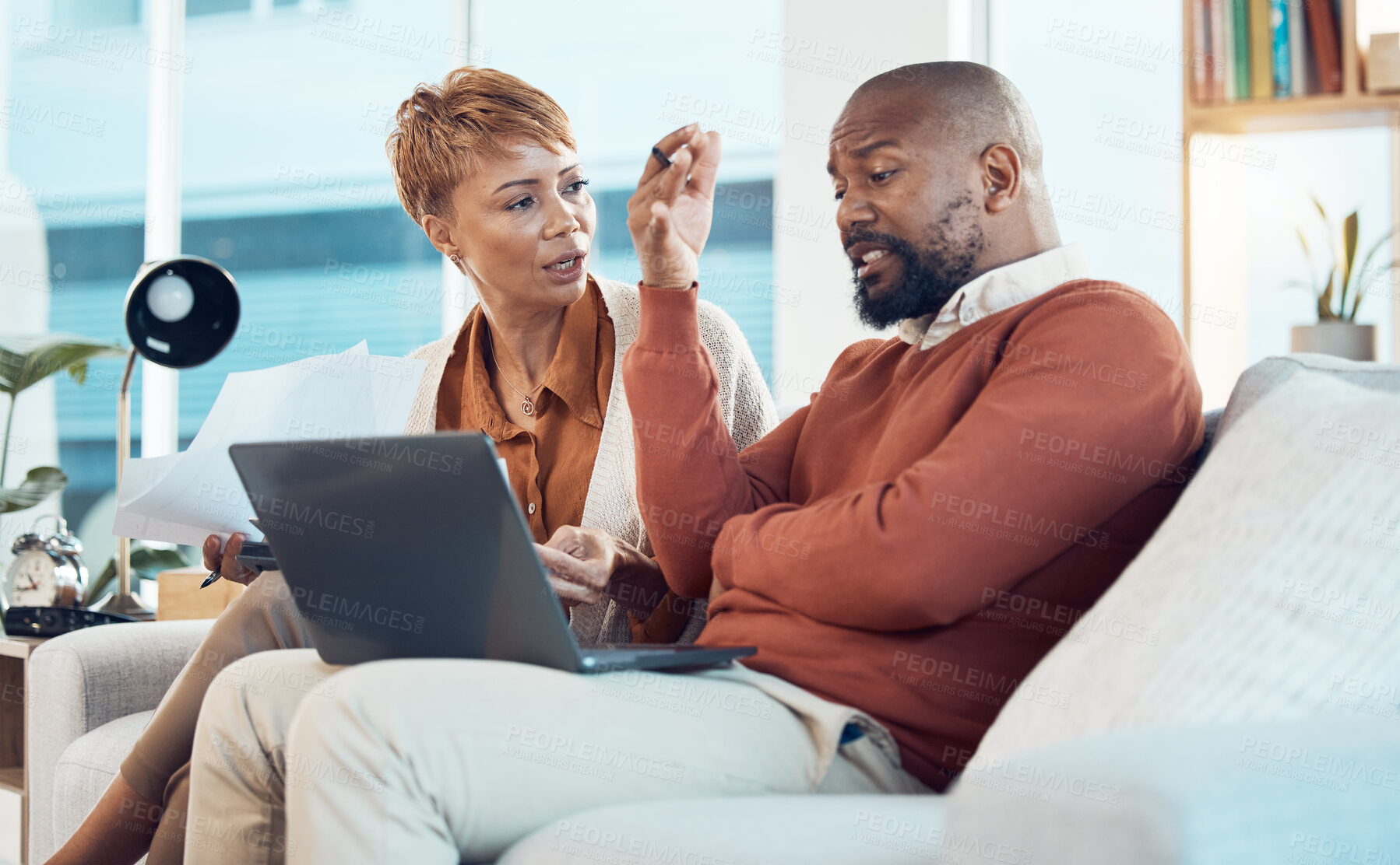 Buy stock photo Laptop, black couple with stress for financial audit, tax debt or house mortgage in living room. Bad finance, tech or black woman and man or worried with savings documents or bill payment paper 