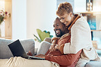 Black couple, laptop and hug together with technology at home, watching a film or video call with 5g network. Black man, black woman and spending quality time on sofa, connection and streaming online