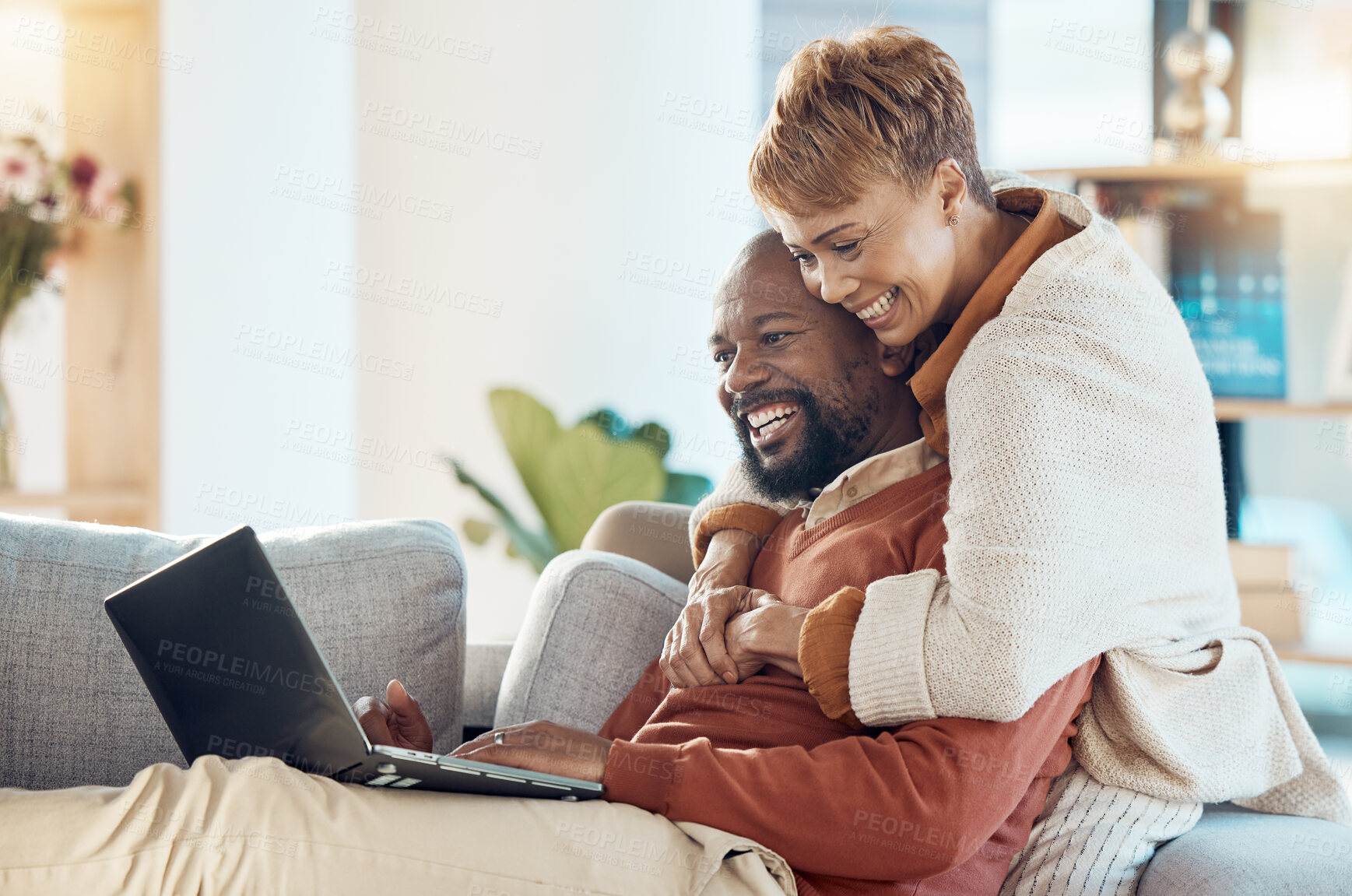 Buy stock photo Black couple, laptop and hug together with technology at home, watching a film or video call with 5g network. Black man, black woman and spending quality time on sofa, connection and streaming online