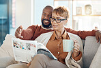 Couple, bonding or reading magazine on sofa in house or home living room for travel ideas, holiday planning or vacation location planning. Happy smile, mature black woman and man with books or coffee