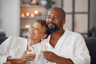 Buy stock photo Spa, couple and romance with champagne relax, happy together and calm bonding on sofa. Married man, woman smile and relationship wellness therapy on romantic honeymoon or relaxing vacation travel 