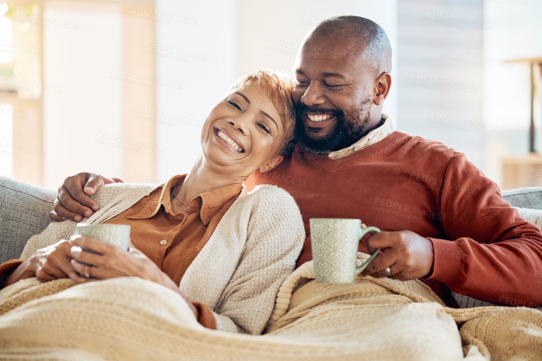 Buy stock photo Love, black couple and coffee with blanket, being happy or smile together for bonding, loving and in lounge. Retirement, romance and senior man with mature woman for quality time, talking and connect