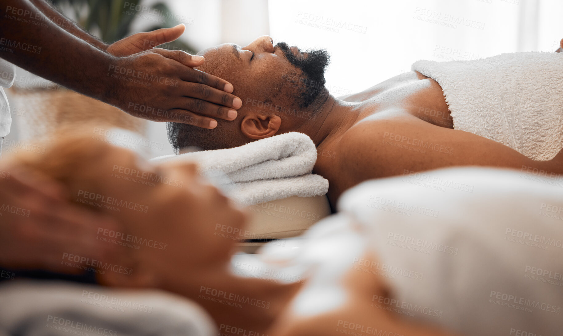 Buy stock photo Relax man, head massage and couple on spa massage table for facial, wellness and stress relief therapy. Salon therapist hands touch face, scalp or healing sleeping black man for cosmetic healthy skin