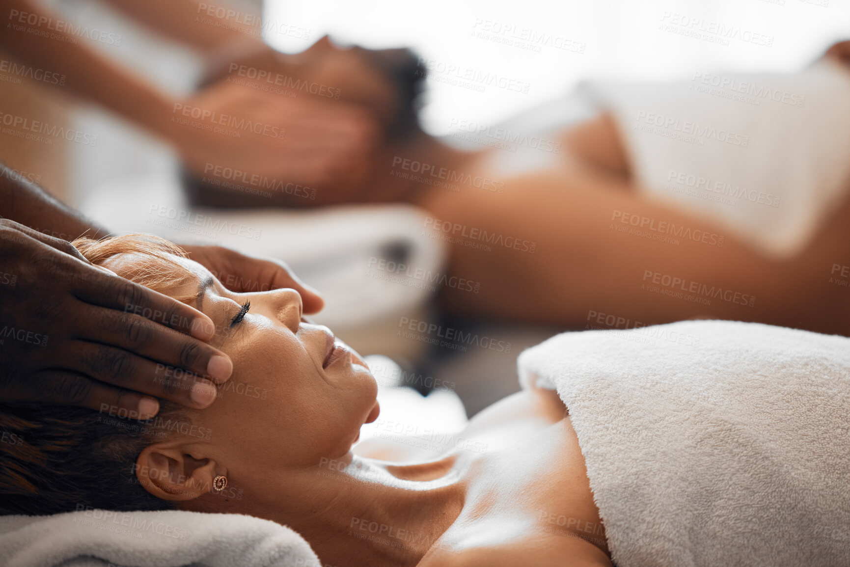 Buy stock photo Head massage, spa bed couple and relax on vacation, holiday or retreat with happiness, peace or zen. Black woman, physical therapy salon and lying for care, health or wellness with black man for rest