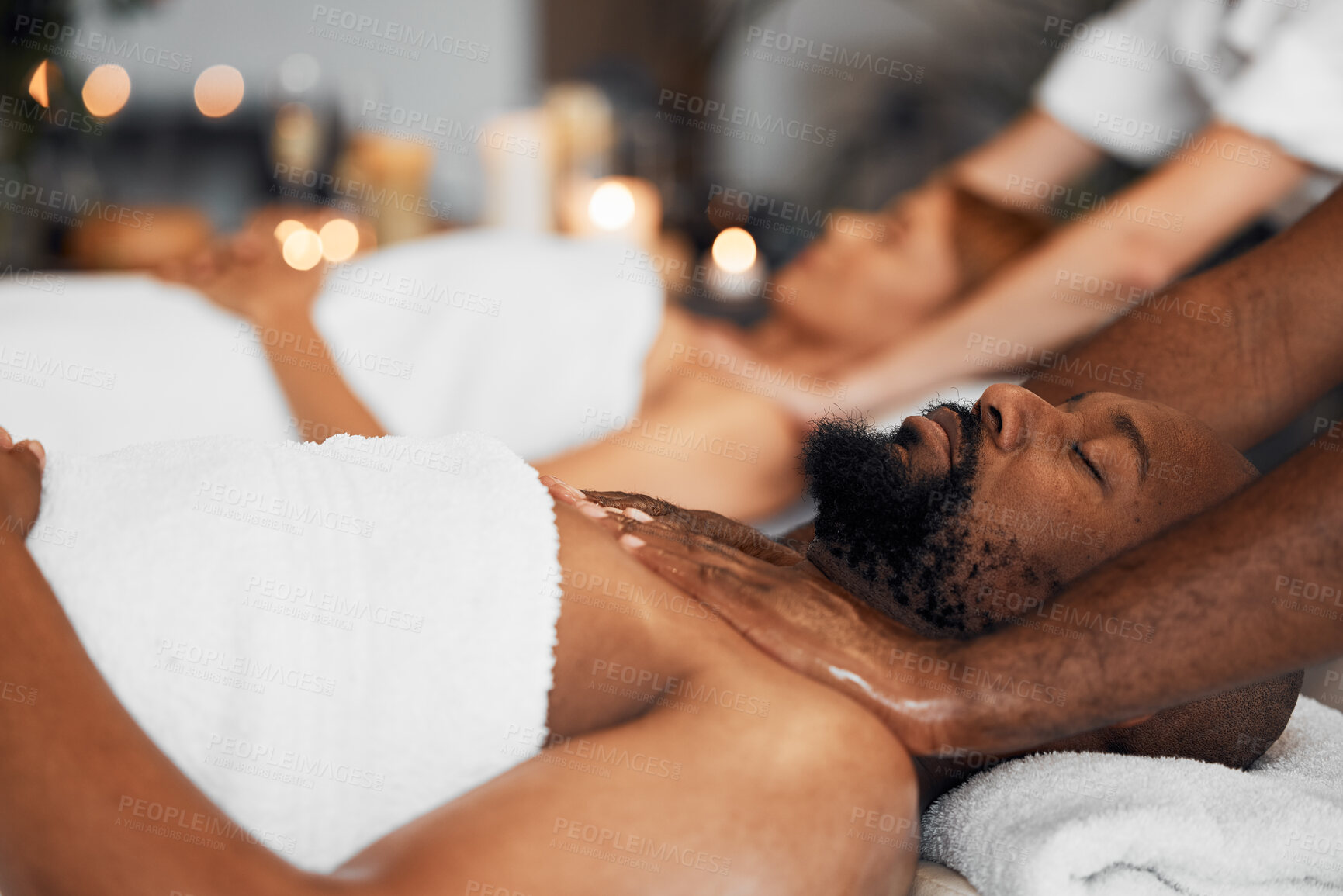 Buy stock photo Black man, spa and body massage for couple wellness, relax therapy and skincare treatment. Salon therapist touch muscle, reflexology and healing of sleeping african guy on bed, stress relief and zen 