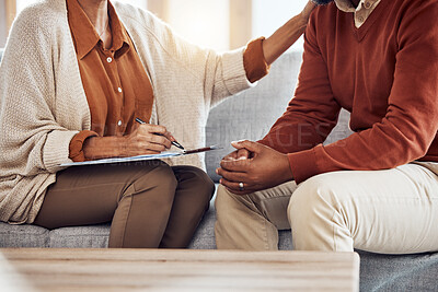 Buy stock photo Therapy, counseling and grief with a black man patient and woman counselor talking in session. Writing, hands and female mental health therapist helping a male client with  depression or anxiety