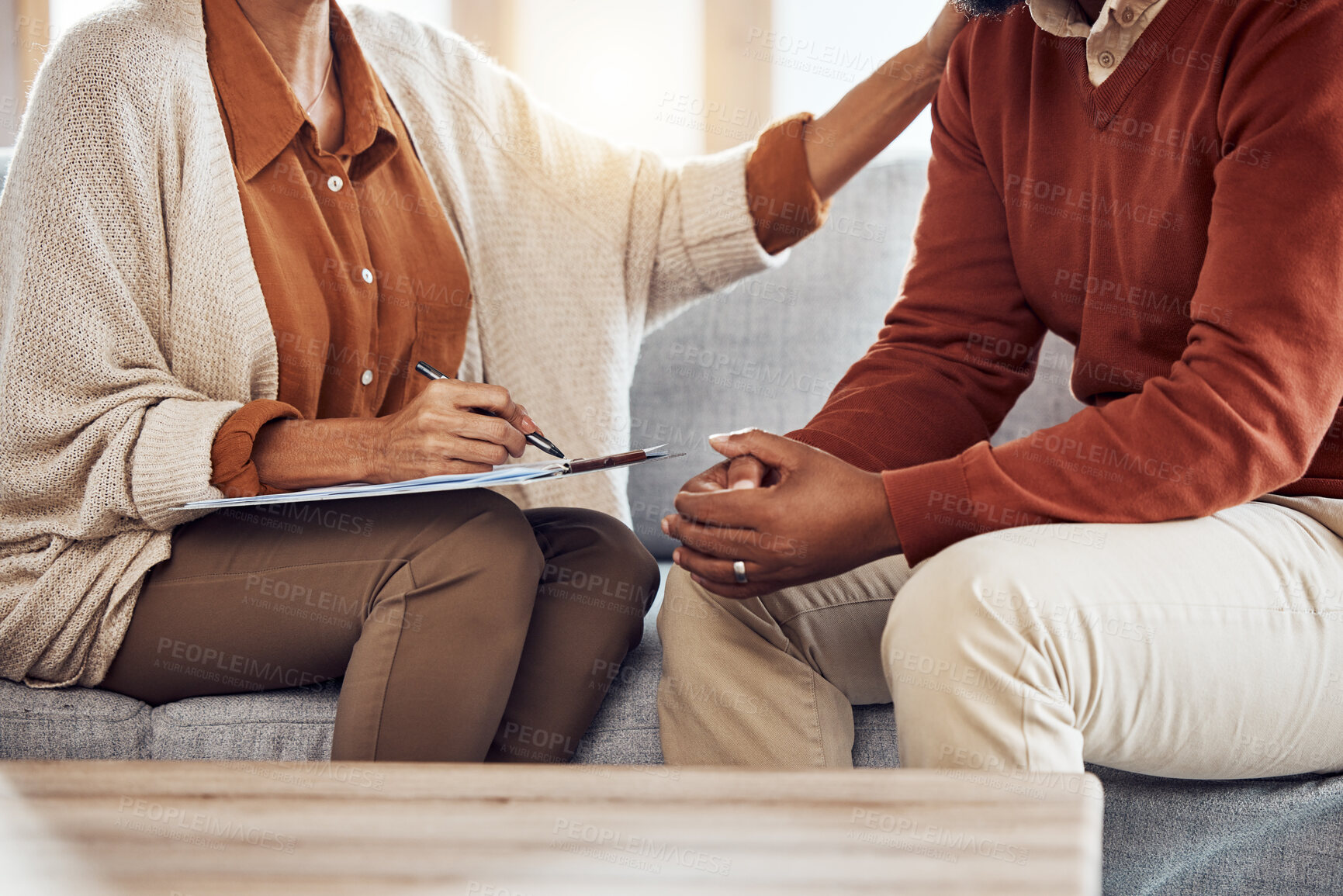 Buy stock photo Therapy, counseling and grief with a black man patient and woman counselor talking in session. Writing, hands and female mental health therapist helping a male client with  depression or anxiety