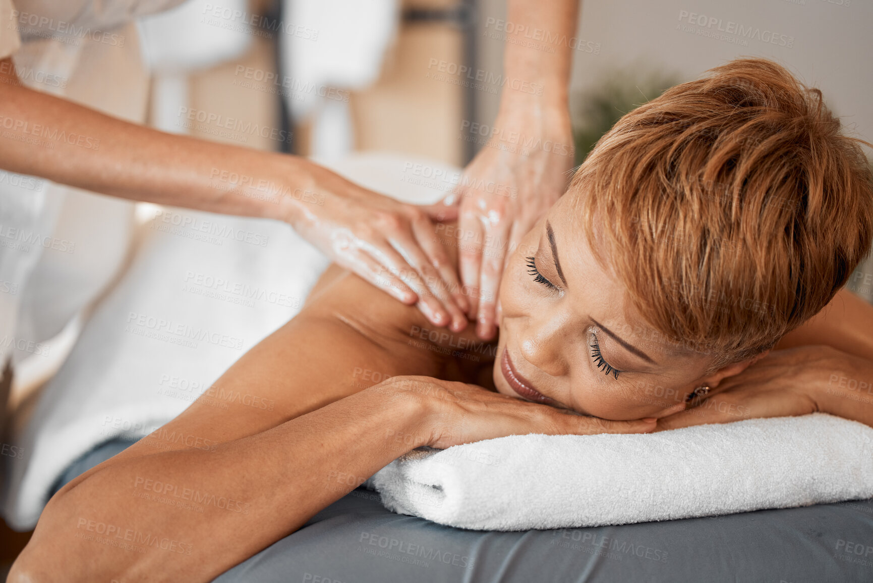 Buy stock photo Spa, wellness and black woman getting luxury back massage for health, beauty and healing treatment. Salon, peace and calm lady relaxing with therapy routine at zen, clean and healing salon at resort.