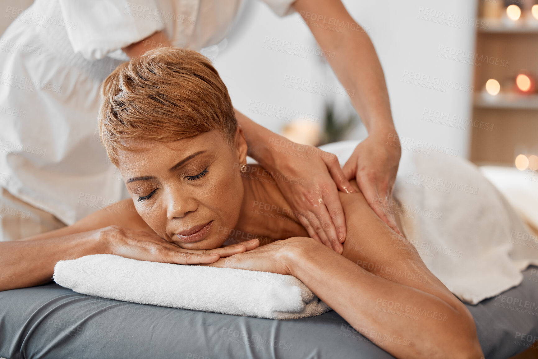 Buy stock photo Hands, relax and black woman at a spa for a massage for back pain and body physical therapy. Relaxing, massage therapist and peaceful person resting and enjoys healthy luxury healing oil treatment