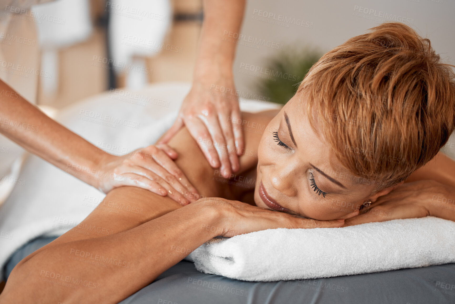 Buy stock photo Black woman, relax and massage being peaceful, calm and enjoy stress relief laying on table. Mature female, at luxury spa and massage therapist for wellness, body care and physical therapy treatment.